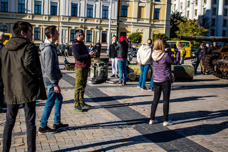 People visiting an open air exhibition and features Russian military equipment that was captured and destroyed during the 2022 Russian invasion of Ukraineのeditorial素材