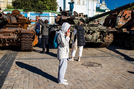 People visiting an open air exhibition and features Russian military equipment that was captured and destroyed during the 2022 Russian invasion of Ukraineのeditorial素材