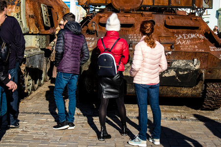 People visiting an open air exhibition and features Russian military equipment that was captured and destroyed during the 2022 Russian invasion of Ukraineのeditorial素材