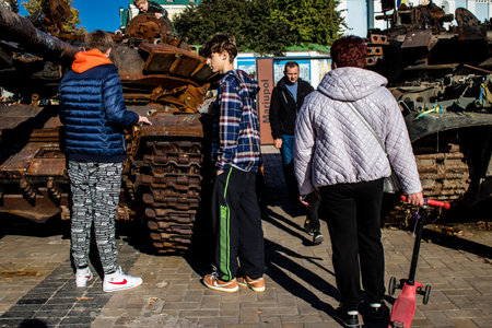 People visiting an open air exhibition and features Russian military equipment that was captured and destroyed during the 2022 Russian invasion of Ukraineのeditorial素材