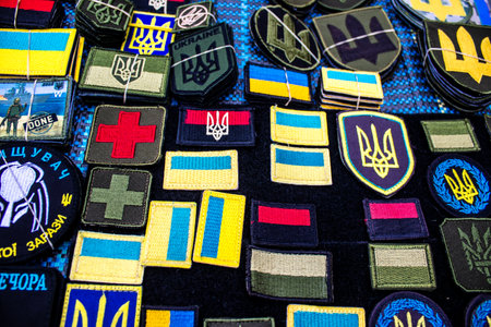 Decorative objects sold on the streets of kyiv in Ukraine, unit patches and other wartime memorabilia revolve around the military spirit and are bought by people as souvenirs on the current war against Russia. The vendors, who have sold trinkets on their のeditorial素材