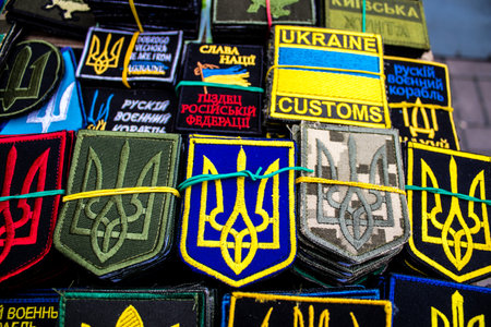 Decorative objects sold on the streets of kyiv in Ukraine, unit patches and other wartime memorabilia revolve around the military spirit and are bought by people as souvenirs on the current war against Russia. The vendors, who have sold trinkets on their のeditorial素材