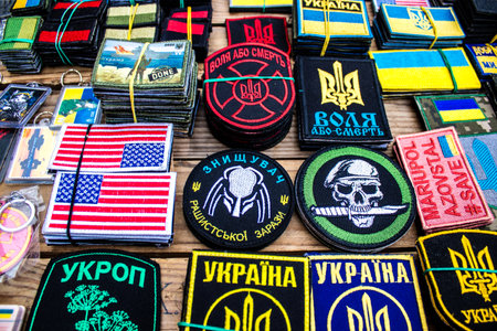 Decorative objects sold on the streets of kyiv in Ukraine, unit patches and other wartime memorabilia revolve around the military spirit and are bought by people as souvenirs on the current war against Russia. The vendors, who have sold trinkets on their のeditorial素材
