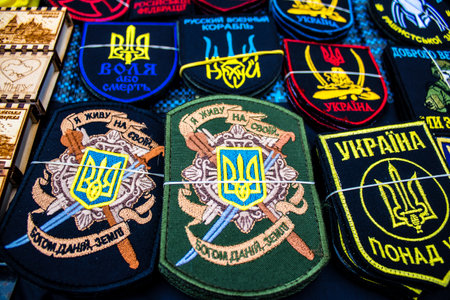 Decorative objects sold on the streets of kyiv in Ukraine, unit patches and other wartime memorabilia revolve around the military spirit and are bought by people as souvenirs on the current war against Russia. The vendors, who have sold trinkets on their のeditorial素材