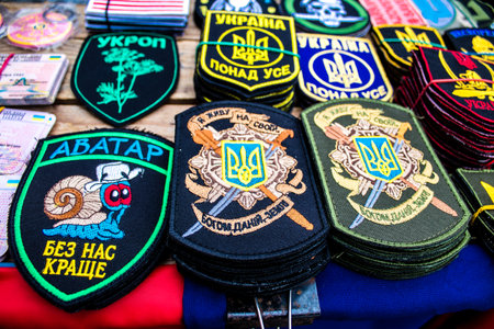 Decorative objects sold on the streets of kyiv in Ukraine, unit patches and other wartime memorabilia revolve around the military spirit and are bought by people as souvenirs on the current war against Russia. The vendors, who have sold trinkets on their のeditorial素材