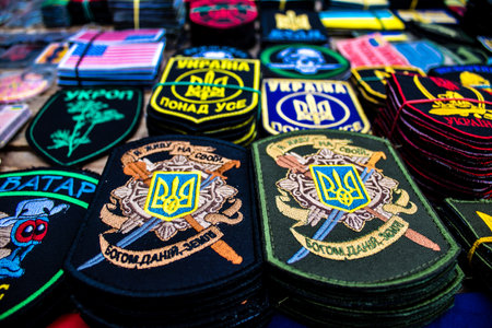 Decorative objects sold on the streets of kyiv in Ukraine, unit patches and other wartime memorabilia revolve around the military spirit and are bought by people as souvenirs on the current war against Russia. The vendors, who have sold trinkets on their のeditorial素材