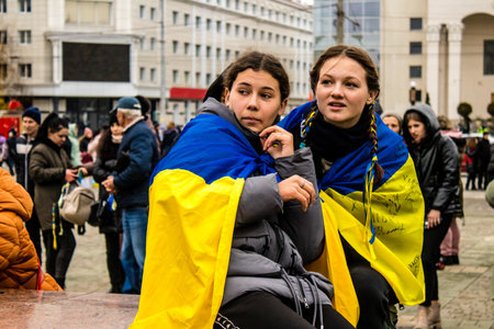 Some citizens of Kherson wearing the flag of Ukraine in the form of a cape celebrate the liberation of the city on Freedom Square in the city center. Russian troops left Kherson after a nine-month occupation and a counter offensive by the Ukrainian army.のeditorial素材