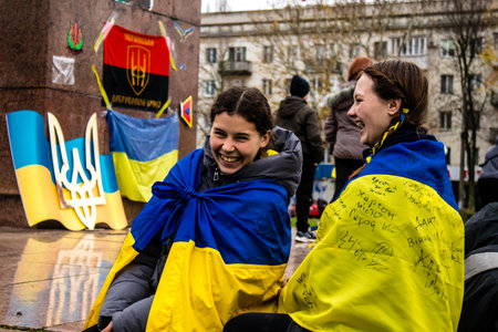 Some citizens of Kherson wearing the flag of Ukraine in the form of a cape celebrate the liberation of the city on Freedom Square in the city center. Russian troops left Kherson after a nine-month occupation and a counter offensive by the Ukrainian army.のeditorial素材