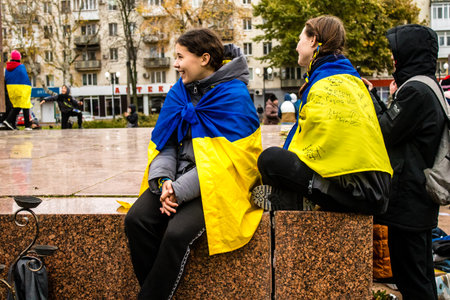 Some citizens of Kherson wearing the flag of Ukraine in the form of a cape celebrate the liberation of the city on Freedom Square in the city center. Russian troops left Kherson after a nine-month occupation and a counter offensive by the Ukrainian army.のeditorial素材