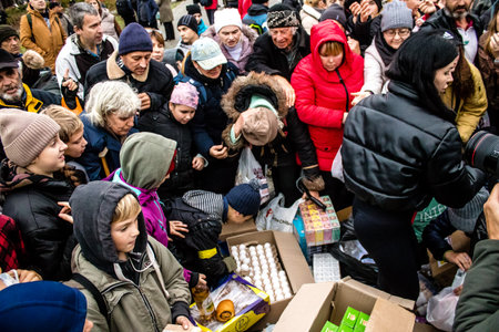 Residents of Kherson, Ukraine, receive food supplies in Freedom Square. The tension is very strong and people are very exasperated. International humanitarian aid is organized when people lack everything.のeditorial素材