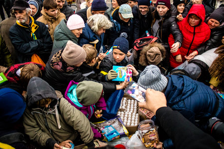Residents of Kherson, Ukraine, receive food supplies in Freedom Square. The tension is very strong and people are very exasperated. International humanitarian aid is organized when people lack everything.のeditorial素材