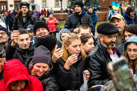 Residents of Kherson, Ukraine, receive food supplies in Freedom Square. The tension is very strong and people are very exasperated. International humanitarian aid is organized when people lack everything.のeditorial素材