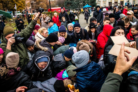 Residents of Kherson, Ukraine, receive food supplies in Freedom Square. The tension is very strong and people are very exasperated. International humanitarian aid is organized when people lack everything.のeditorial素材