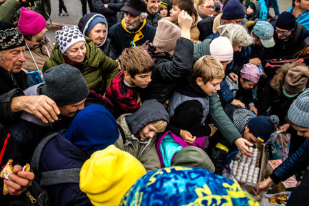 Residents of Kherson, Ukraine, receive food supplies in Freedom Square. The tension is very strong and people are very exasperated. International humanitarian aid is organized when people lack everything.のeditorial素材