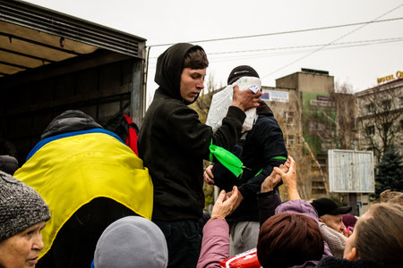 Citizens of Kherson receive humanitarian aid at Freedom Square in the city center. Russian troops left Kherson after a nine-month occupation and a counter-offensive by the Ukrainian armyのeditorial素材
