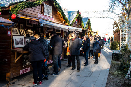 People visiting the Christmas Market in Reims will take place from December 1 to 30, 2022. On the Promenades Jean-Louis Schneiter, the 150 chalets of the "Christmas Village" will be deployed. The stands are made up of a multitude of gastronomic, artisanalのeditorial素材