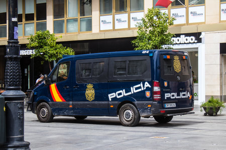 Sevilla, Spain - June 06, 2023 Police car driving in the city center of Sevilla, an emblematic city and the capital of Andalusia.のeditorial素材