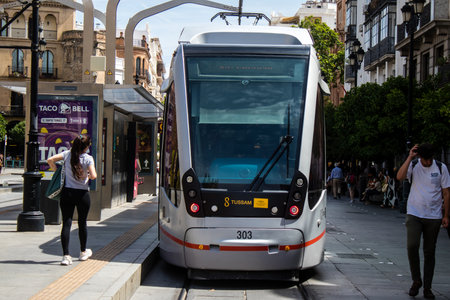 Sevilla, Spain - June 06, 2023 2023 Electric tram driving in the streets of Sevilla and part of the transport system of the city, the fares are not expensive.のeditorial素材
