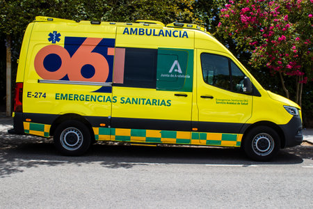 Sevilla, Spain - June 06, 2023 Ambulance driving in the city center of Sevilla, an emblematic city and the capital of Andalusia.のeditorial素材
