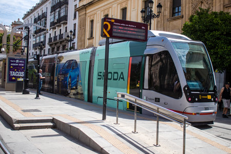 Sevilla, Spain - June 06, 2023 2023 Electric tram driving in the streets of Sevilla and part of the transport system of the city, the fares are not expensive.のeditorial素材