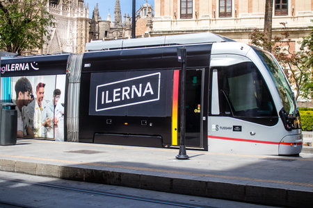 Sevilla, Spain - June 06, 2023 2023 Electric tram driving in the streets of Sevilla and part of the transport system of the city, the fares are not expensive.のeditorial素材