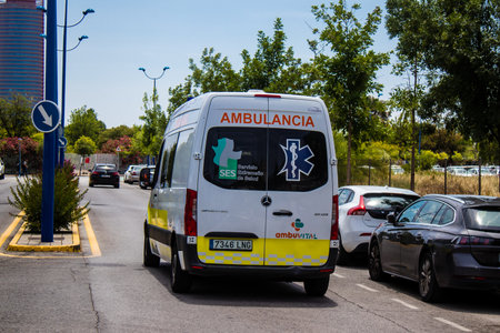 Sevilla, Spain - June 06, 2023 Ambulance driving in the city center of Sevilla, an emblematic city and the capital of Andalusia.のeditorial素材