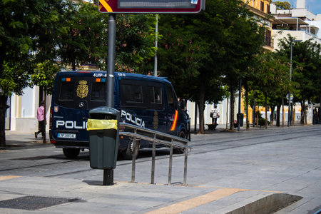 Sevilla, Spain - June 06, 2023 Police car driving in the city center of Sevilla, an emblematic city and the capital of Andalusia.のeditorial素材