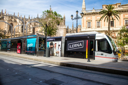 Sevilla, Spain - June 06, 2023 2023 Electric tram driving in the streets of Sevilla and part of the transport system of the city, the fares are not expensive.のeditorial素材