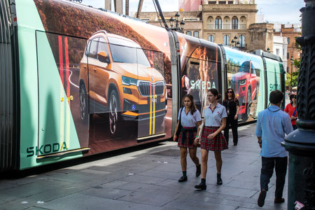 Sevilla, Spain - June 06, 2023 2023 Electric tram driving in the streets of Sevilla and part of the transport system of the city, the fares are not expensive.のeditorial素材