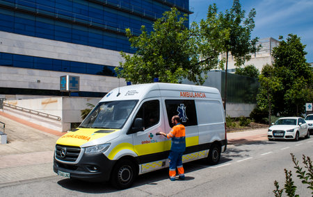 Sevilla, Spain - June 06, 2023 Ambulance driving in the city center of Sevilla, an emblematic city and the capital of Andalusia.のeditorial素材