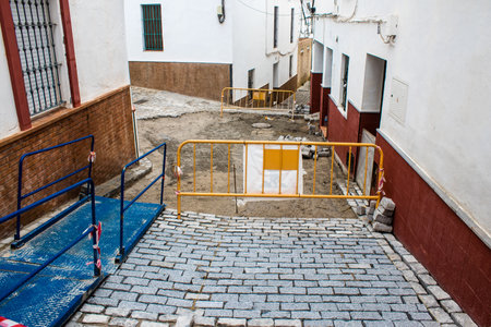 Carmona, Spain - June 08, 2023 Public works for the development and repair of a pipe on a street in the old town of Carmona, a traditional white village in southern Spain.のeditorial素材