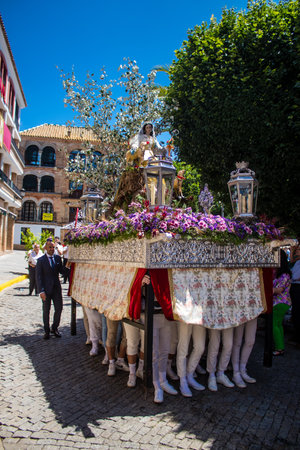 Honorary citizen participating in the Corpus Christi procession, their mission is to carry the religious statues. This age-old tradition of the Catholic faith to process the real presence of Jesus. Eucharistic processions take place in the narrow streets のeditorial素材
