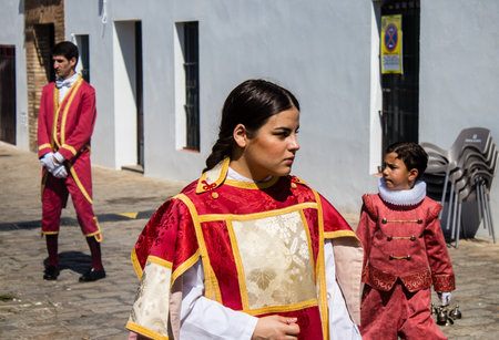Catholic parish child participating in the Corpus Christi procession, an age-old tradition of the Catholic faith to process the real presence of Jesus. Eucharistic processions take place in the narrow streets of the old town of Carmona which is reputed toのeditorial素材