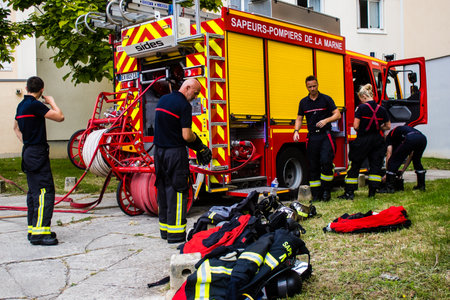 Firefighters are working to put out a fire that broke out in one of the buildings in the Croix Rouge district of Reims in France. Firefighters acted quickly and the fire was contained.のeditorial素材
