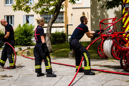 Firefighters are working to put out a fire that broke out in one of the buildings in the Croix Rouge...