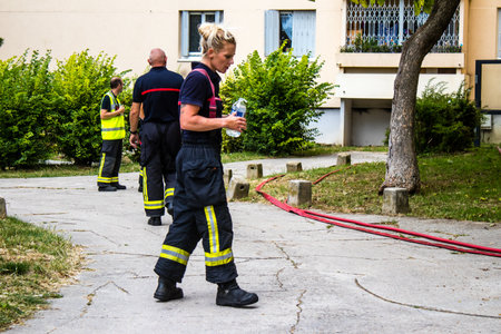 Firefighters are working to put out a fire that broke out in one of the buildings in the Croix Rouge district of Reims in France. Firefighters acted quickly and the fire was contained.のeditorial素材
