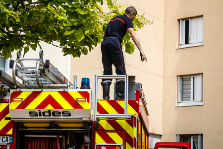 Firefighters are working to put out a fire that broke out in one of the buildings in the Croix Rouge district of Reims in France. Firefighters acted quickly and the fire was contained.のeditorial素材