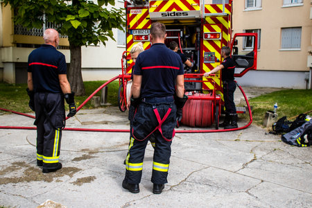 Firefighters are working to put out a fire that broke out in one of the buildings in the Croix Rouge district of Reims in France. Firefighters acted quickly and the fire was contained.のeditorial素材
