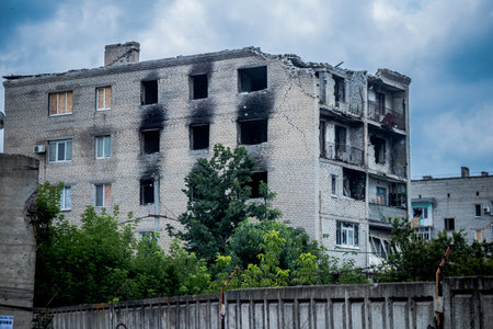 The buildings were badly damaged by the bombardments during the battle of Lyman which followed the Russian invasion. Civilians are targets, these are war crimes.のeditorial素材