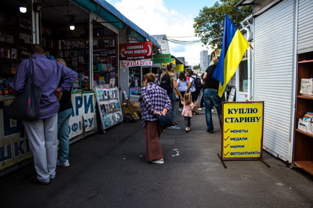 People shopping at book market Petrivka located in Kyiv, Ukraine. Famous for its great range of books. Sprawling open air market with stalls selling secondhand books. Despite the war and the fact that there are no tourists, this place remains very popularのeditorial素材