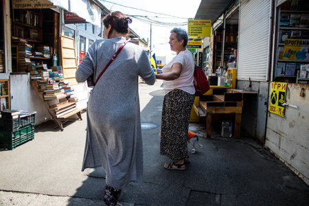 People shopping at book market Petrivka located in Kyiv, Ukraine. Famous for its great range of books. Sprawling open air market with stalls selling secondhand books. Despite the war and the fact that there are no tourists, this place remains very popularのeditorial素材