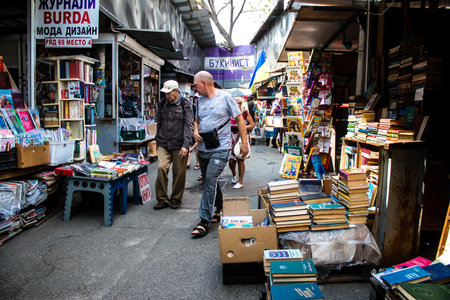 People shopping at book market Petrivka located in Kyiv, Ukraine. Famous for its great range of books. Sprawling open air market with stalls selling secondhand books. Despite the war and the fact that there are no tourists, this place remains very popularのeditorial素材