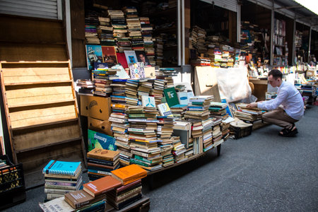 People shopping at book market Petrivka located in Kyiv, Ukraine. Famous for its great range of books. Sprawling open air market with stalls selling secondhand books. Despite the war and the fact that there are no tourists, this place remains very popularのeditorial素材