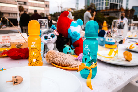 Tel Aviv, Israel - December 17, 2023 People placed toys and objects on the table along with photos...