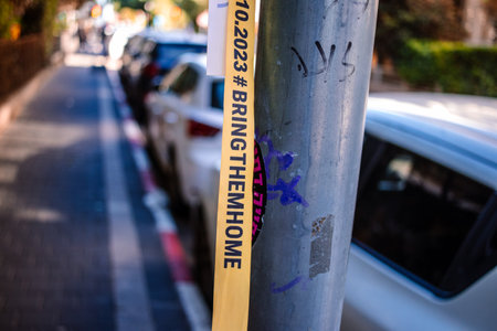 Tel Aviv, Israel - December 15, 2023. Dizengoff Square Memorial, Gifts and posters of the faces of hostages kidnapped by Hamas during the October 7, 2023 terrorist attack are on display.のeditorial素材