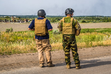 Donbass, Ukraine, July 06, 2024 Journalists at the frontline in the gray zone between Ukrainian and Russian armed forces. This buffer zone is dangerous and fighting rages in the region.のeditorial素材