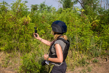 Donbass, Ukraine, July 06, 2024 Journalists at the frontline in the gray zone between Ukrainian and Russian armed forces. This buffer zone is dangerous and fighting rages in the region.のeditorial素材