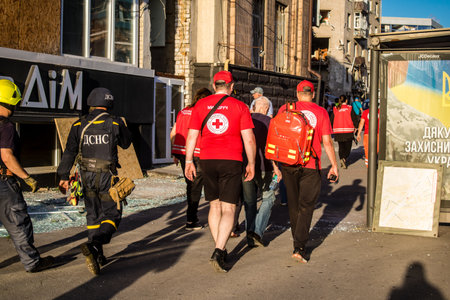 Kharkiv, Ukraine, June 22, 2024 Red Cross volunteers provide logistical assistance to rescuers at the scene of the airstrike with a Russian UMPB D30 guided bomb in central Kharkiv.のeditorial素材