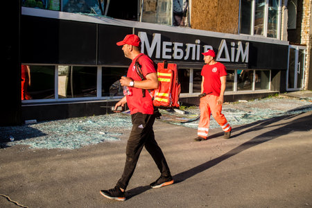 Kharkiv, Ukraine, June 22, 2024 Rescuers help evacuate the injured following an airstrike with a...