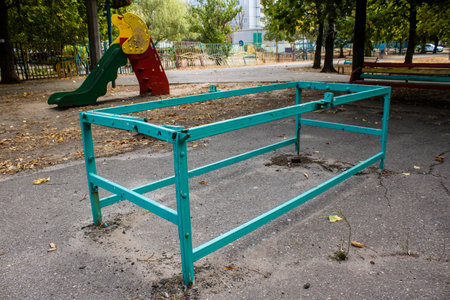 Kharkiv, Ukraine, September 12, 2024 Abandoned playground in front of a damaged building in the Saltivka district. Children were evacuated from this place after a massive attacks of Russian missiles.の写真素材